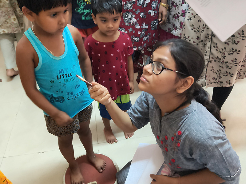 NSS volunteers conducting height and weight mapping of slum children
